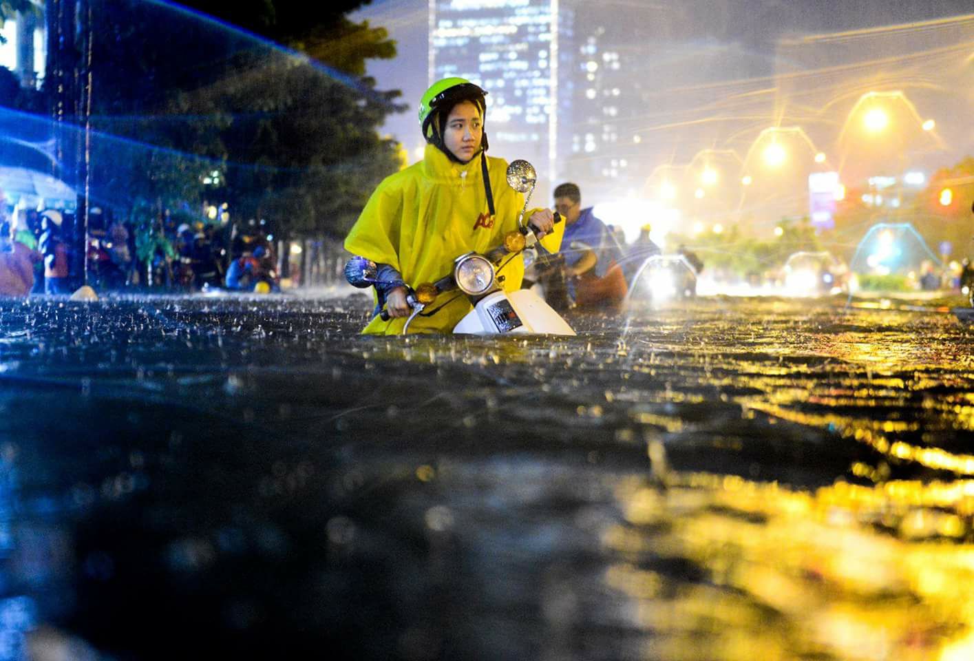 A girl walks through a flooded street in central Ho Chi Minh City on September 26, 2016